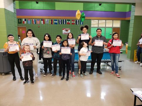students holding certificates for improved attendance 